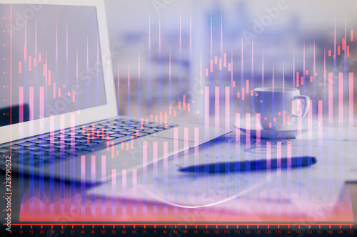 Forex graph hologram on table with computer background. Double exposure. Concept of financial markets. © peshkova