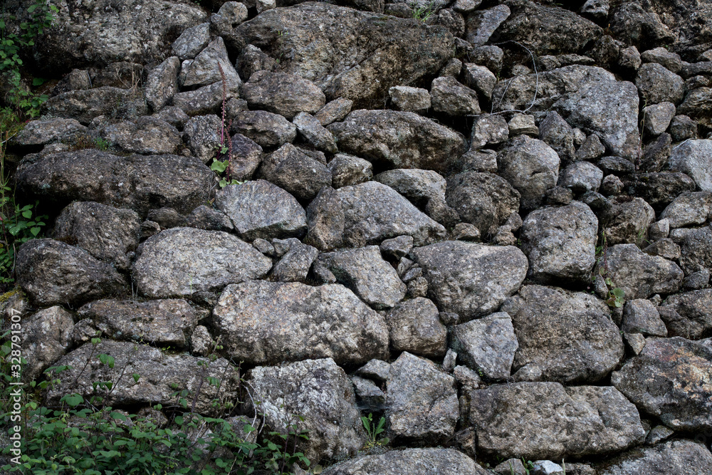 Texture of a stone wall, old stone position wall without cement.