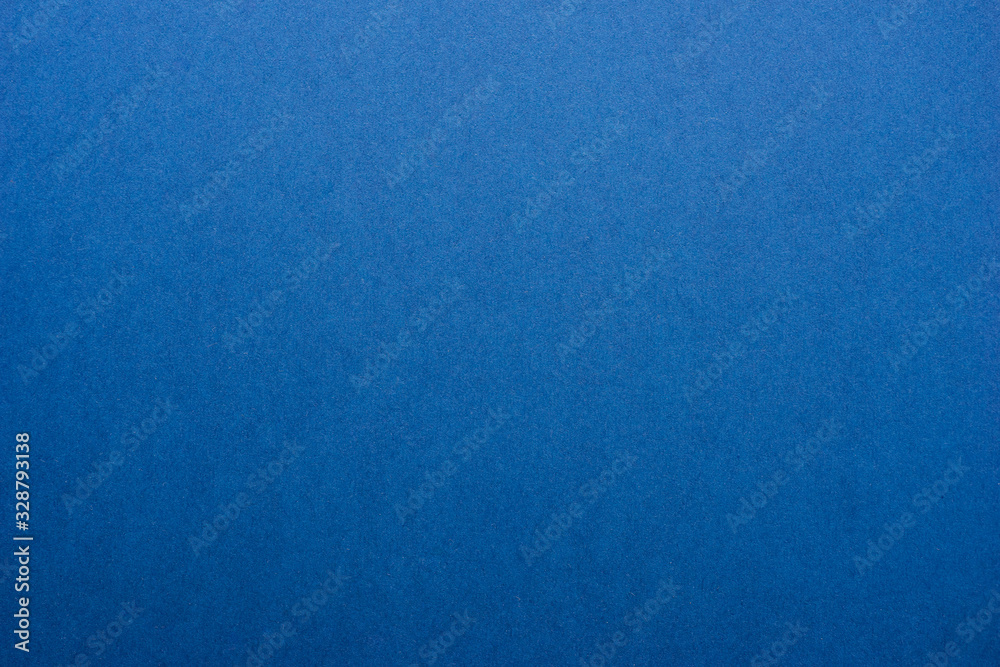 Classic blue background - abstract color trend year background. Texture and texture - paper deep blue color. Top view and soft focus.