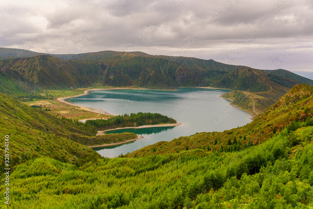Panoramic view of natural landscape in the Azores, wonderful island of Portugal. Beautiful lagoons in volcanic craters and green fields. Tourist attraction and travel destination. Panoramic view of natural landscape in the Azores, wonderful island of Portugal. Beautiful lagoons in volcanic craters and green fields. Tourist attraction and travel destination.