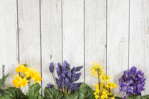 One of the first spring flowers on the wooden background, arranged in the bouquet