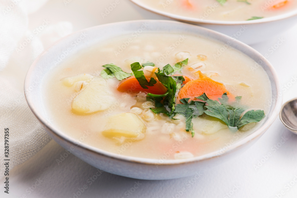 Barley soup, pearl barley in white bowl Barley soup, pearl barley in white bowl