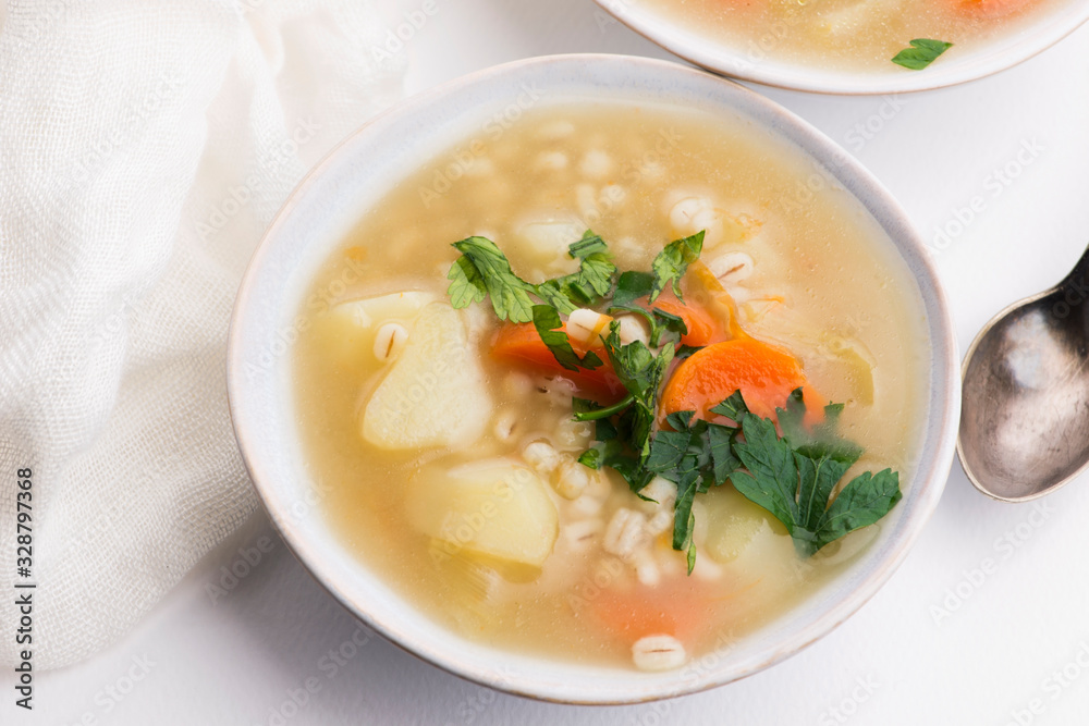 Barley soup, pearl barley in white bowl