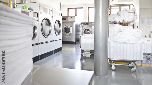 Big industrial laundry washing machines clean zone bright modern interior