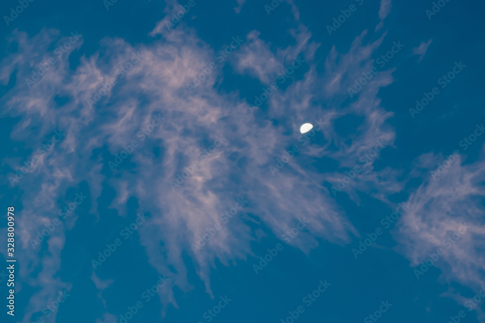 blue sky with clouds and the moon