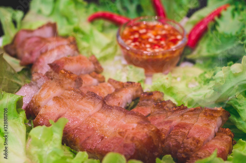 Thai roasted crispy pork on lettuce with Thai Spicy Sauce, Close up view