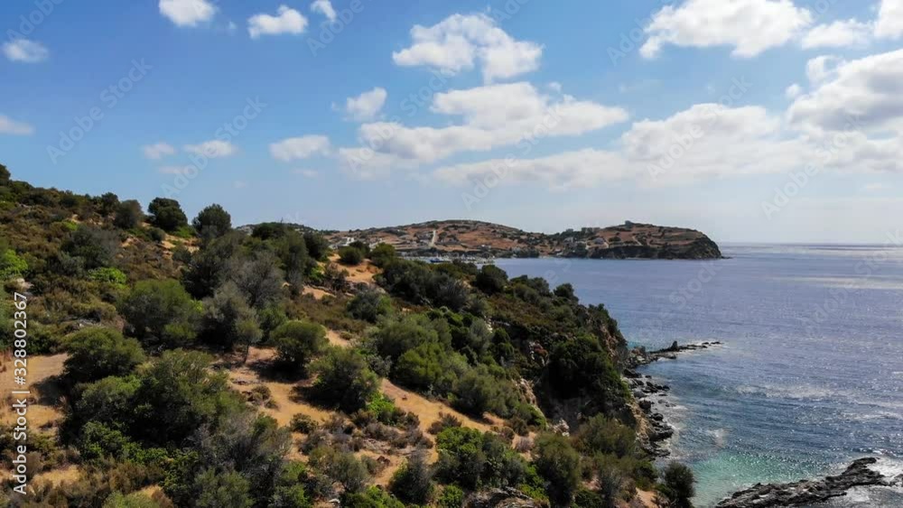 aerial view of the sea and the rocky coast with a Greek village in the background aerial view of the sea and the rocky coast with a Greek village in the background