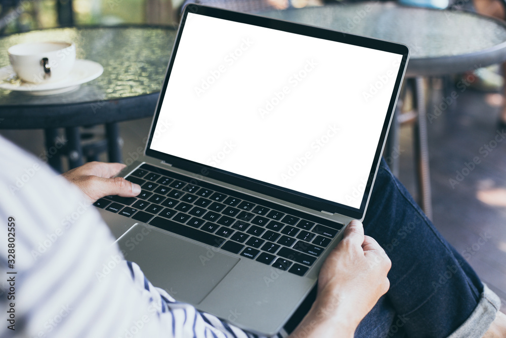 mockup image blank screen computer with white background for advertising text,hand woman using laptop contact business search information on desk at coffee shop.marketing and creative design mockup image blank screen computer with white background for advertising text,hand woman using laptop contact business search information on desk at coffee shop.marketing and creative design