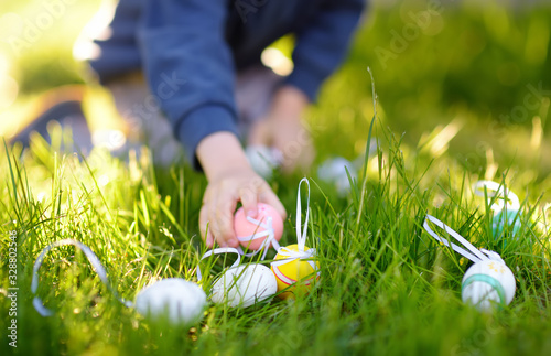 Cuadro en lienzo Little boy hunting for easter egg in spring garden on Easter day