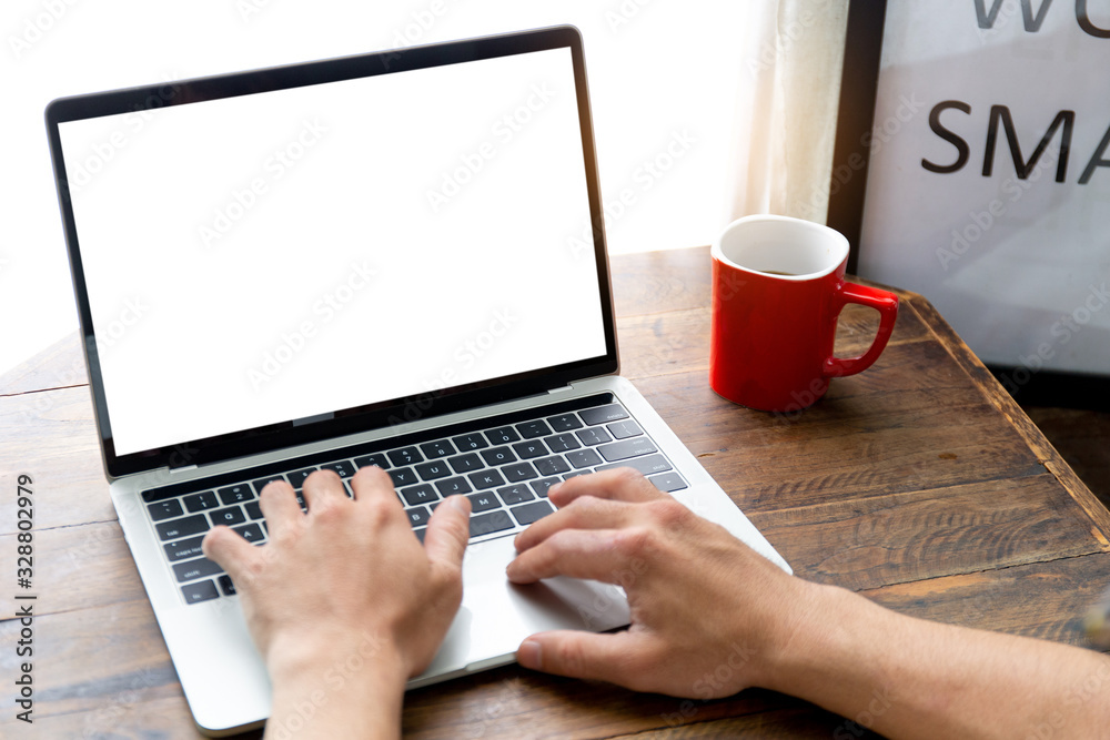 mockup image blank screen computer with white background for advertising text,hand man using laptop contact business search information on desk at coffee shop.marketing and creative design mockup image blank screen computer with white background for advertising text,hand man using laptop contact business search information on desk at coffee shop.marketing and creative design