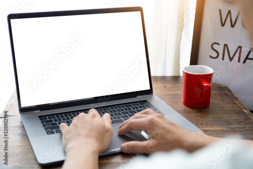 mockup image blank screen computer with white background for advertising text,hand man using laptop contact business search information on desk at coffee shop.marketing and creative design