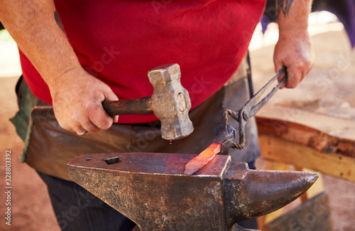 Fotografía Blacksmith making a knife blade on an anvil