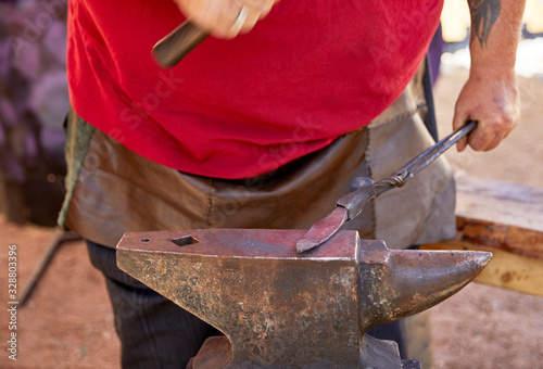 Fotografía Blacksmith making a knife blade on an anvil