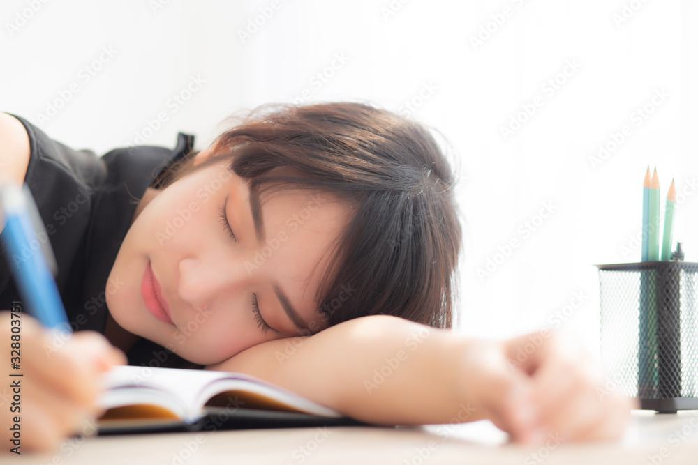 Beautiful portrait young asian woman smile and happy writing learning exam or homework and lying with desk, lifestyle beauty asia girl with work, education and business concept. Beautiful portrait young asian woman smile and happy writing learning exam or homework and lying with desk, lifestyle beauty asia girl with work, education and business concept.