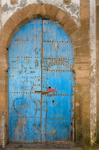 Old dilapidated blue door with stonework in Essaouira Medina Morocco © Reimar