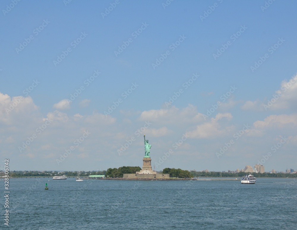 statue of liberty and water in New York with boats