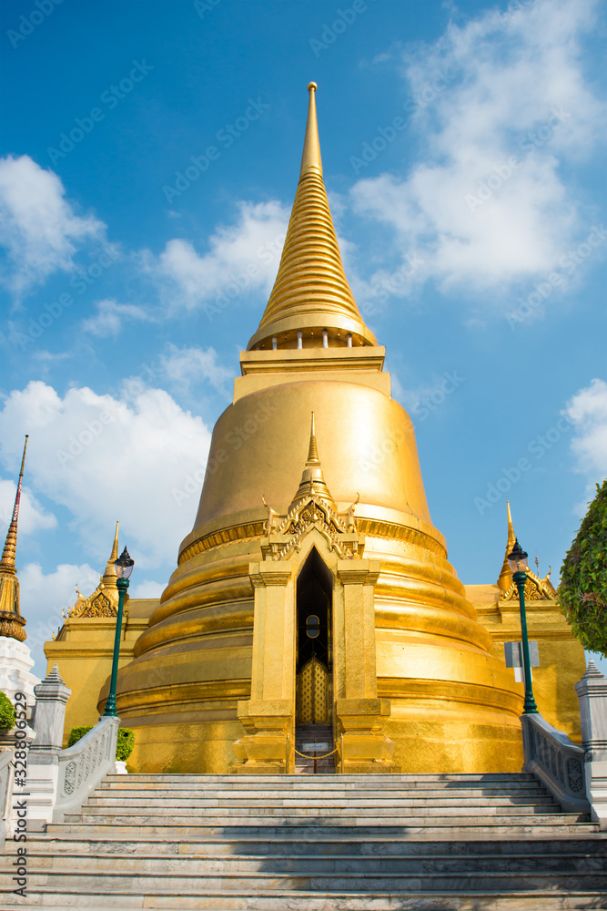 Naklejka premium View of Phra Si Rattana Chedi - gold stupa near Temple of Emerald Buddha. Grand Palace, Bangkok, Thailand