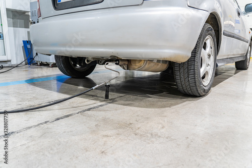 Emission control in the exhaust of an old car at a vehicle inspection station