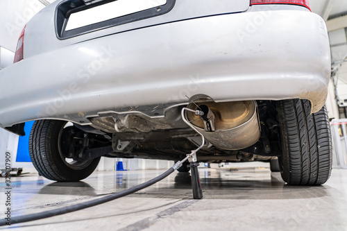 Emission control in the exhaust of an old car at a vehicle inspection station
