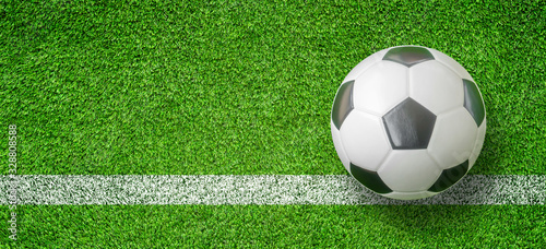 Top view of Soccer ball or Football on white line green artificial grass.