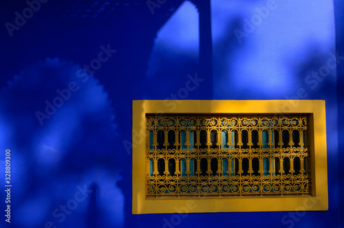 Islamic Art Museum of Marrakech at Majorelle Garden with yellow window and cobalt blue shadows photo