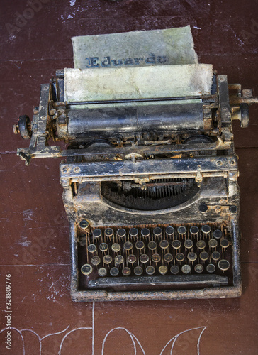 Rusty old antique typewriter on a wooden table