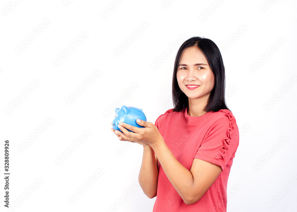Cute asian woman with hand holding blue piggy bank on white backgrounds for saving money Cute asian woman with hand holding blue piggy bank on white backgrounds for saving money