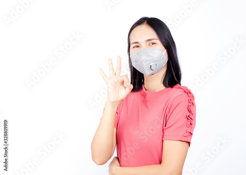 Cute asian woman portrait wearing mask and show okay hands gesture for Covid 19 or coronavirus concept