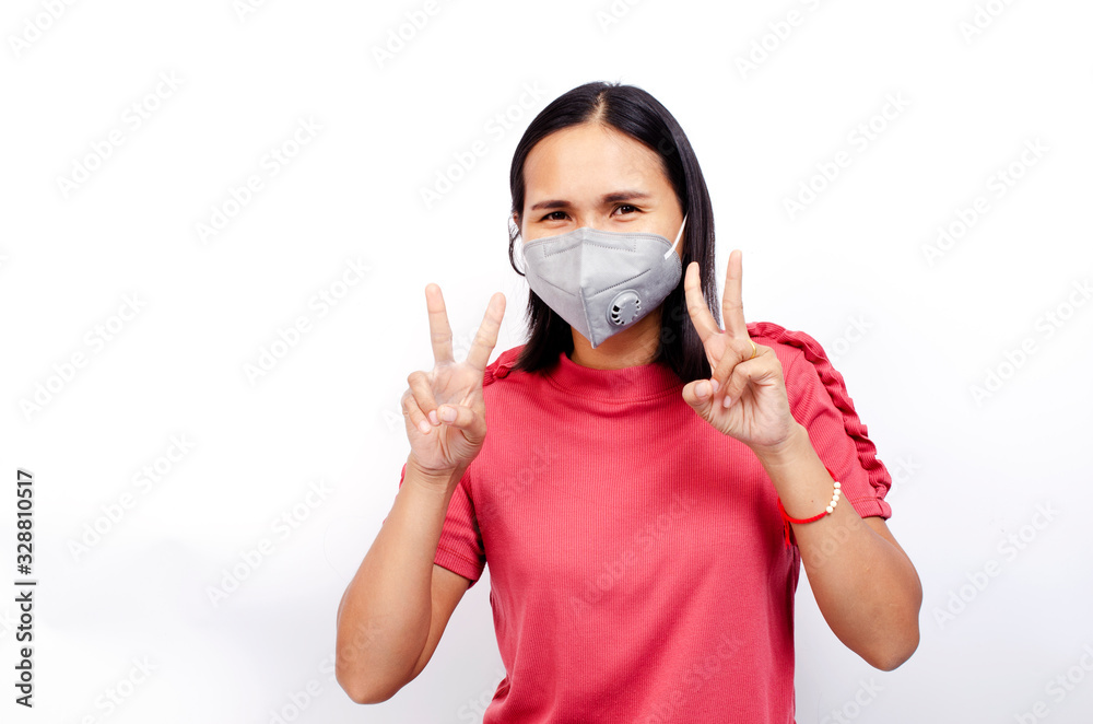 Cute asian woman wearing mask for protect Covid 19 or coronavirus and show fights hands gesture on white backgrounds Cute asian woman wearing mask for protect Covid 19 or coronavirus and show fights hands gesture on white backgrounds
