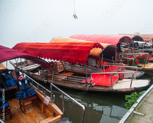 Traditional chinese boat  view in Wuhan city Donghu east lake during rainy season. photo