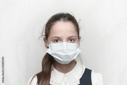 coronavirus covid-19 epidemic outbreak health care concept of young beautiful little girl wearing medical mask and school uniform
