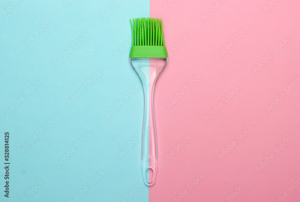 Kitchen tools. Kitchen brush on pink blue pastel background. Minimalism. Top view