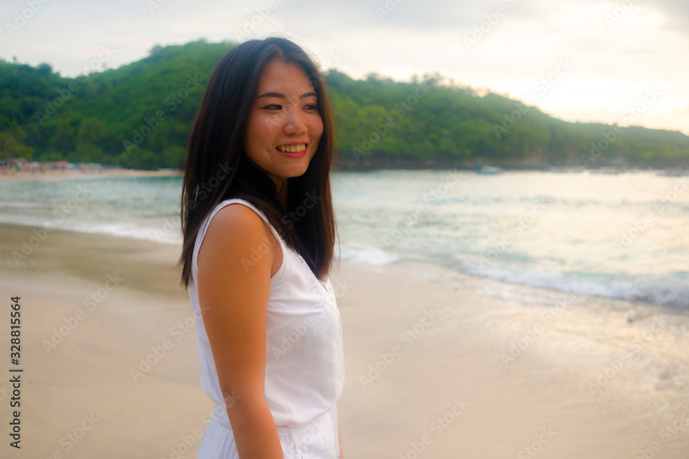 outdoors lifestyle portrait of young beautiful and happy Asian Chinese woman in Summer dress enjoying cheerful walk at tropical paradise beach relaxed and blissful in holidays travel outdoors lifestyle portrait of young beautiful and happy Asian Chinese woman in Summer dress enjoying cheerful walk at tropical paradise beach relaxed and blissful in holidays travel
