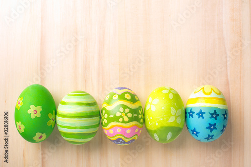Happy Easter with colorful eggs at paintbrush for do it yourself on brown wooden floor top view with copy space