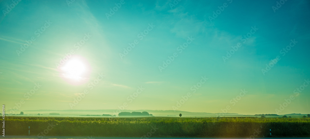 Germany, Frankfurt, Sunrise, a large green landscape with a body of water Germany, Frankfurt, Sunrise, a large green landscape with a body of water