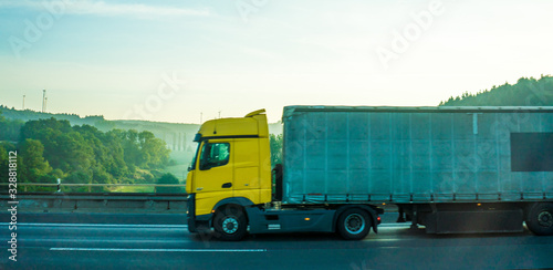 Germany, Frankfurt, Sunrise, a large blue truck is parked on the side of a road