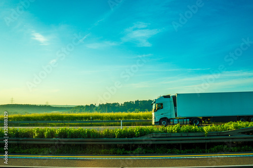 Germany, Frankfurt, Sunrise, a large green field with trees in the background