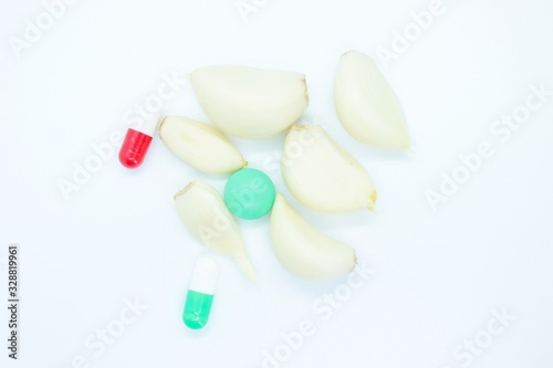 Garlic  vitamin pills  medicine located on a white background