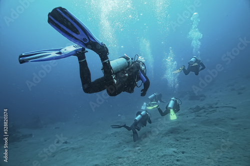 diver flippers view from the back underwater, underwater view of the back of a person swimming with scuba diving photo