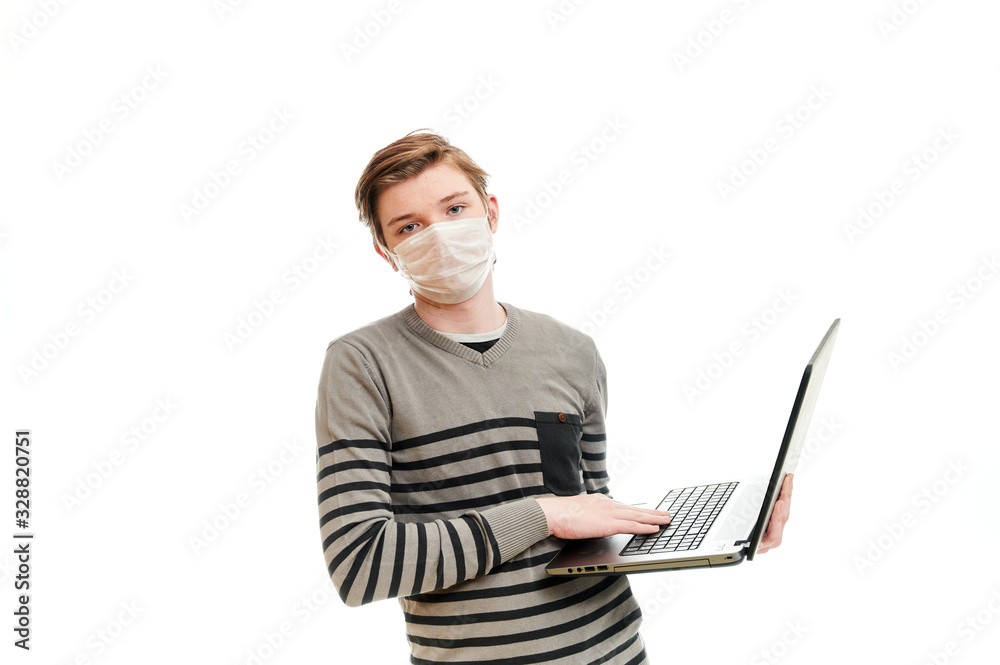 Isolate photo of Caucasian guy in medical mask with a laptop in his hands Isolate photo of Caucasian guy in medical mask with a laptop in his hands