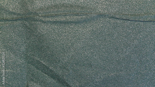 greenish crumpled paper background with sparkles photo