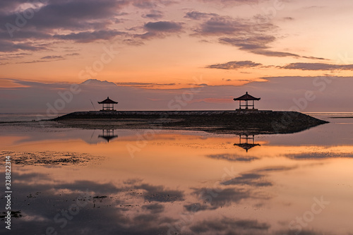 Sunset or sunrise on the beach in Bali in Sanur.  beautiful temples in calm water with great colors © Jan