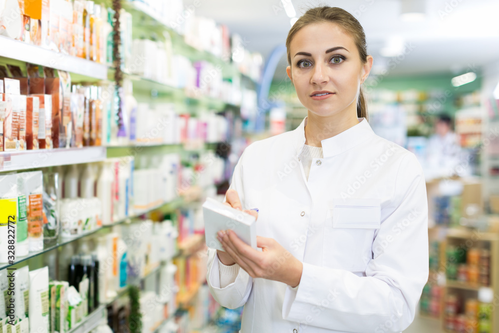 girl pharmacist is inventorying medicines