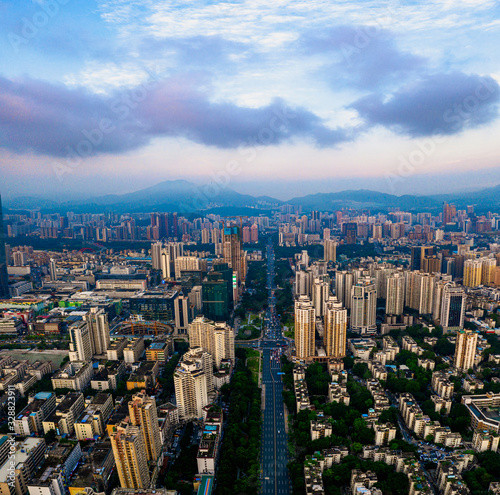 A vertically-merged aerial panorama, showcasing the sunset cityscape and cars waiting for green light on the road in downtown, China. © Jingye