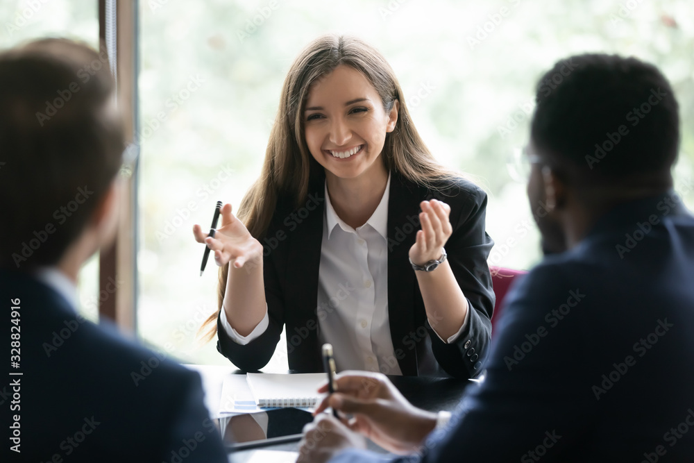Happy multiracial businesspeople gather at office desk brainstorm ...