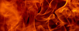 Abstract fire flame glowing burning on black dark background, photo for creative graphic design wallpaper, beautiful flame light motion of bonfire