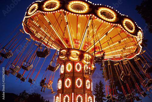 Tablou canvas Carousel Merry-go-round in amusement park at a night city