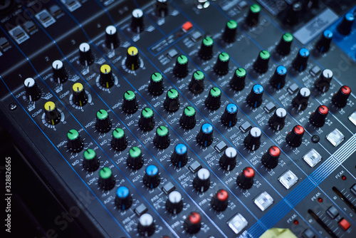 Audio music mixer console on a black background. Sound studio mixing desk