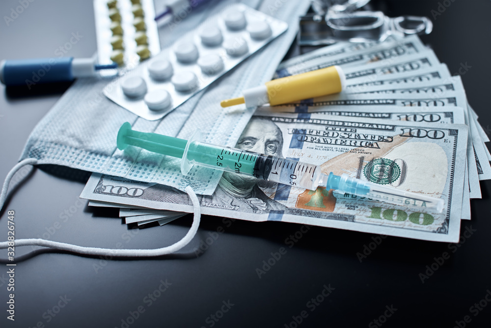Pills, protective mask, medical items and dollar bills on dark background. Expensive medicine concept. Pharmaceutical industry and medical insurance Pills, protective mask, medical items and dollar bills on dark background. Expensive medicine concept. Pharmaceutical industry and medical insurance