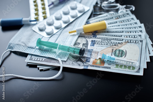 Pills, protective mask, medical items and dollar bills on dark background. Expensive medicine concept. Pharmaceutical industry and medical insurance